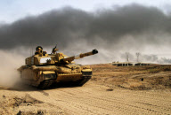 British tank moves into position for final assault on southern Iraqi city of Basra, April 2003

