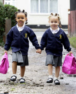 Four-year-old black and white twins Marcia and Millie Biggs enjoy their first day at school, Birmingham, West Midlands, Britain - 12 Sep 2010