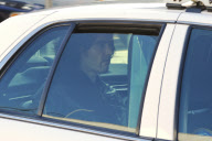 Russell Brand Taken Away in the Back of a Police Car