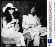 John Lennon And Yoko Ono Arrive At Heathrow Airport From Vienna On April 1. The Couple Are Dressed Entirely In White. After The Campaign Against Them In The Press Earlier John And Yoko Were Surprised To Be Welcomed Home By Interviewers In England. At