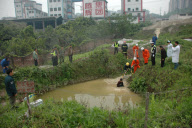 91-year-old grandmother trapped in muddy pool for 10 hours, Chongqing, China - 17 Apr 2010