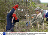 PRINCE CHARLES TRYS HIS HAND AT HEDGE LAYING AFTER TOURING THE NATIONAL HEDGE LAYING COMPETITION AT HOME FARM, TETBURY, BRITAIN - 29 OCT 2005