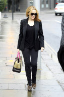 SINGER KYLIE MINOGUE LOOKING GOOD AND DRESSED TO IMPRESS AS SHE LEAVES HOME FOR THE MORNING. KYLIES SPORTING JEANS WITH ZIPS FROM HIP TO HEM ON THE OUTSIDE LEGS. TEAMED WITH A BLAZER AND LEOPARD PRINT HIGH HEALS AND DESIGNER HAND BAG