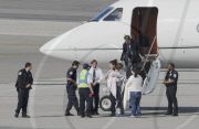 Katie Holmes Touches Down With Suri 