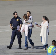 Katie Holmes Touches Down With Suri 