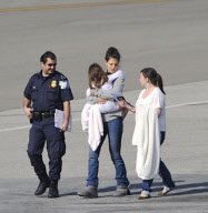 Katie Holmes Touches Down With Suri 