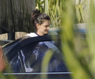 Katie Holmes Touches Down With Suri 