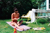 woman sitting on a blanket reading