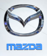 The logo for Mazda on display at the Chicago Auto Show