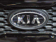 The logo for Kia on display at the Chicago Auto Show