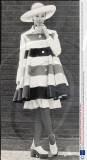 Royal College School Of Fashion Designs Show 1972. Stephen Adnitt - Swirling Coat In Bold Stripes Of Red White And Black Cotton Worn Over A Pleated Skirt With Ribbed Stockings And Contemporary Clogs.