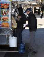 MICHAEL DOUGLAS RUNS OUT OF HIS CAR TO GET "HEALTHY" HOT DOG ONLY TO REALIZE HE DOESN'T HAVE ANY MONEY AND HAS TO BORROW SOME FROM HIS DRIVER. 