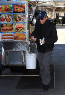 MICHAEL DOUGLAS RUNS OUT OF HIS CAR TO GET "HEALTHY" HOT DOG ONLY TO REALIZE HE DOESN'T HAVE ANY MONEY AND HAS TO BORROW SOME FROM HIS DRIVER. 