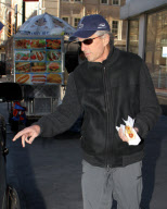 MICHAEL DOUGLAS RUNS OUT OF HIS CAR TO GET "HEALTHY" HOT DOG ONLY TO REALIZE HE DOESN'T HAVE ANY MONEY AND HAS TO BORROW SOME FROM HIS DRIVER. 