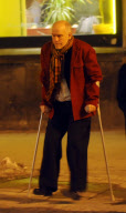 John Malkovich on crutches after breaking his leg