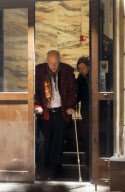 John Malkovich on crutches after breaking his leg