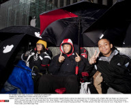 NY: CROWDS WAIT IN RAIN FOR RELEASE OF iPAD II