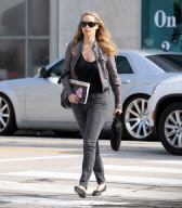 Elizabeth Berkley holds a "Ask Elizabeth" notebook