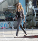 Elizabeth Berkley holds a "Ask Elizabeth" notebook