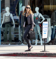 Elizabeth Berkley holds a "Ask Elizabeth" notebook
