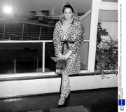 URSULA ANDRESS, WEARING AN OCELOT COAT AND MATCHING CALF-LENGTH BOOTS, LEAVES LONDON AIRPORT FOR SWEEDEN IN CHRISTMAS. 22ND DECEMBER 1965.