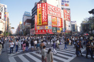 Pedestrians and billboards in Shinjuku district of Tokyo