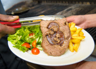 Beefeater Grill puts its own stamp on the Royal Wedding by serving customers with a royal rump steak of the happy couple-London, United Kingdom.