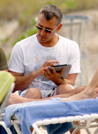 Adam Shankman on the beach with his iPad