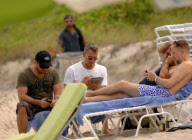 Adam Shankman on the beach with his iPad