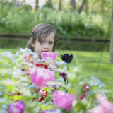 Little girl enjoying spring flowers