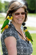 Woman takes pet parrots shopping, cycling, and skiing, Loughborough, Britain - May 2011