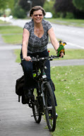 Woman takes pet parrots shopping, cycling, and skiing, Loughborough, Britain - May 2011