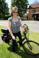Woman takes pet parrots shopping, cycling, and skiing, Loughborough, Britain - May 2011