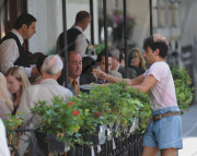 SACHA BARON COHEN AKA BORAT GRABS SOME FOOD FROM A TABLE OF UNSUSPECTING DINERS AND IS BEING CHASED BY A WAITER WHILE FILMING "THE DICTATOR: IN NEW YORK