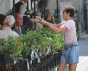 SACHA BARON COHEN AKA BORAT GRABS SOME FOOD FROM A TABLE OF UNSUSPECTING DINERS AND IS BEING CHASED BY A WAITER WHILE FILMING "THE DICTATOR: IN NEW YORK