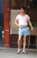 SACHA BARON COHEN AKA BORAT GRABS SOME FOOD FROM A TABLE OF UNSUSPECTING DINERS AND IS BEING CHASED BY A WAITER WHILE FILMING "THE DICTATOR: IN NEW YORK