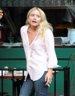 MARY KATE OLSEN WITH A MALE FRIEND SMOKING AND DRINKING OUTSIDE A RESTAURANT IN THE WEST VILLAGE  NEW YORK