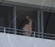 While on the balcony of his SoHo hotel room in Miami, Florida, the ever charismatic "Rock of Ages" star, Tom Cruise, gives the crowd below a little taste of the upcoming film as he gives a shirtless demonstration of his ability to 'rock out' with a microp