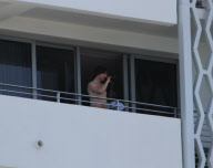 While on the balcony of his SoHo hotel room in Miami, Florida, the ever charismatic "Rock of Ages" star, Tom Cruise, gives the crowd below a little taste of the upcoming film as he gives a shirtless demonstration of his ability to 'rock out' with a microp