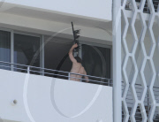 While on the balcony of his SoHo hotel room in Miami, Florida, the ever charismatic "Rock of Ages" star, Tom Cruise, gives the crowd below a little taste of the upcoming film as he gives a shirtless demonstration of his ability to 'rock out' with a microp