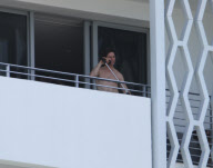 While on the balcony of his SoHo hotel room in Miami, Florida, the ever charismatic "Rock of Ages" star, Tom Cruise, gives the crowd below a little taste of the upcoming film as he gives a shirtless demonstration of his ability to 'rock out' with a microp