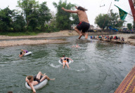 Backpackers Tubing on the Nam Song river in Vang Vieng, Laos - Mar 2011