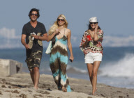 Paris Hilton and Brandon Davis smoking cigarettes on the beach