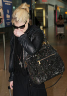 AN EMOTIONAL KELLY OSBOURNE AT HEATHROW