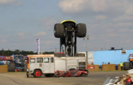 Stunt driver's attempt to drive monster truck over fire engine backfires at Santa Pod Raceway, Northamptonshire, Britain - 21 Aug 2011