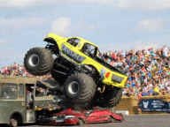 Stunt driver's attempt to drive monster truck over fire engine backfires at Santa Pod Raceway, Northamptonshire, Britain - 21 Aug 2011