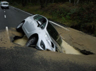 Car Swallowed by Gaping Hole in Road Caused by a Burst Water Main, Surrey, Britain - 05 Oct 2011