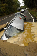 Car Swallowed by Gaping Hole in Road Caused by a Burst Water Main, Surrey, Britain - 05 Oct 2011