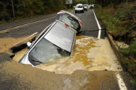 Car Swallowed by Gaping Hole in Road Caused by a Burst Water Main, Surrey, Britain - 05 Oct 2011