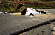Car Swallowed by Gaping Hole in Road Caused by a Burst Water Main, Surrey, Britain - 05 Oct 2011